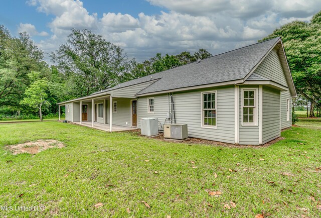5887 Scotland Rd, Bentonia, MS 39040 - back of house with a patio area, a shingled roof, central AC unit, and a yard