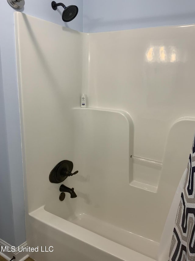 room details featuring shower / bathtub combination