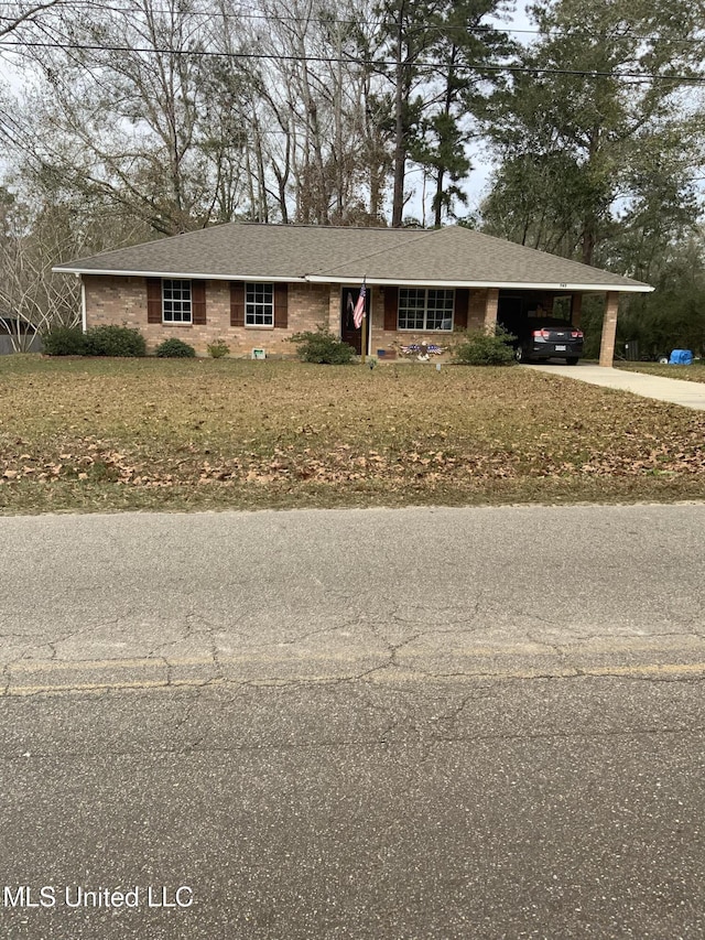 single story home featuring a front lawn and a carport