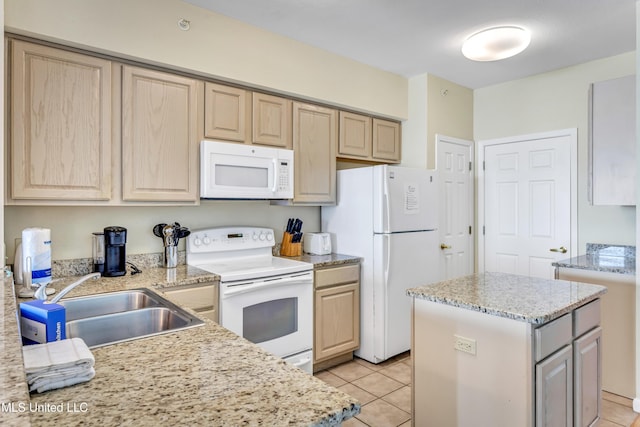 kitchen with light tile patterned flooring, light brown cabinets, white appliances, sink, and a kitchen island