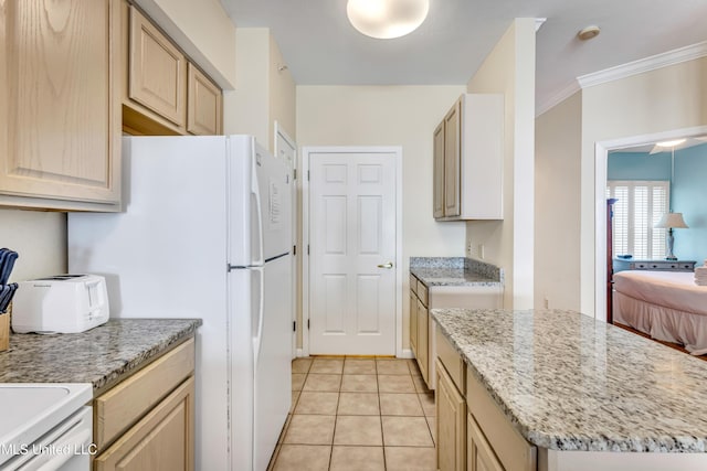 kitchen with light stone counters, light brown cabinetry, light tile patterned flooring, and ornamental molding