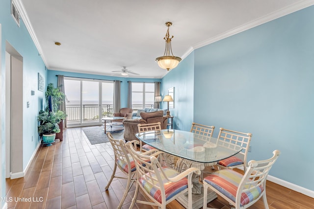 dining area featuring ceiling fan and crown molding