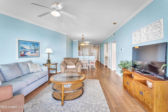 living room featuring crown molding, ceiling fan, and light hardwood / wood-style floors