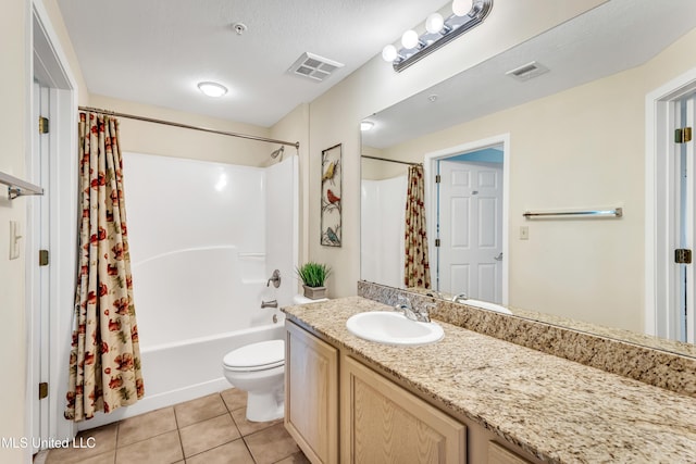 full bathroom with tile patterned floors, a textured ceiling, toilet, vanity, and shower / tub combo