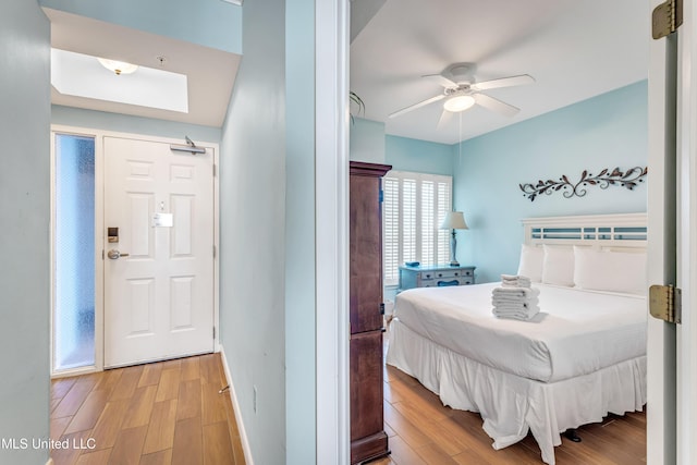 bedroom with ceiling fan and light wood-type flooring