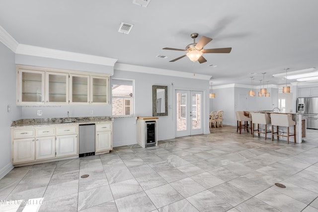 7528 Crooked Stick Dr, Diamondhead, MS 39525 - kitchen with stainless steel fridge with ice dispenser, a ceiling fan, glass insert cabinets, refrigerator, and a breakfast bar area