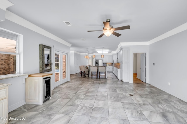 7528 Crooked Stick Dr, Diamondhead, MS 39525 - living area featuring wine cooler, a ceiling fan, ornamental molding, and light marble finish floors