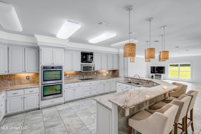 7528 Crooked Stick Dr, Diamondhead, MS 39525 - kitchen with appliances with stainless steel finishes, a kitchen breakfast bar, open floor plan, light stone countertops, and crown molding