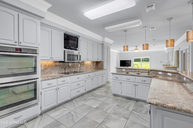 7528 Crooked Stick Dr, Diamondhead, MS 39525 - kitchen featuring stainless steel appliances, crown molding, backsplash, hanging light fixtures, and light stone countertops