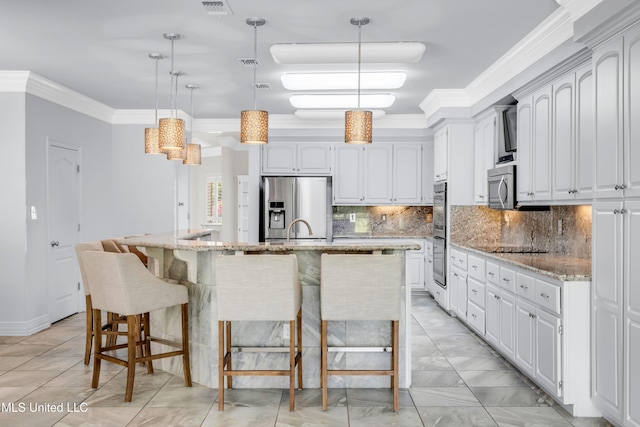 7528 Crooked Stick Dr, Diamondhead, MS 39525 - kitchen featuring stainless steel appliances, crown molding, decorative backsplash, light stone counters, and a large island with sink