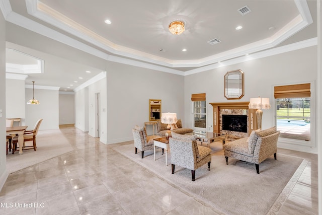 7528 Crooked Stick Dr, Diamondhead, MS 39525 - living room featuring a tray ceiling, crown molding, a fireplace, recessed lighting, and light marble finish flooring