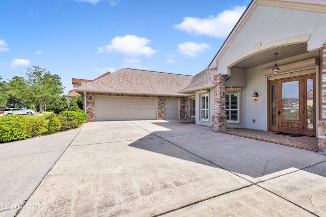 7528 Crooked Stick Dr, Diamondhead, MS 39525 - view of front of property with stucco siding, a garage, concrete driveway, and a shingled roof
