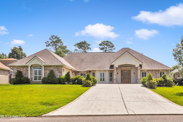 7528 Crooked Stick Dr, Diamondhead, MS 39525 - view of front of property featuring a front lawn, concrete driveway, brick siding, and stucco siding