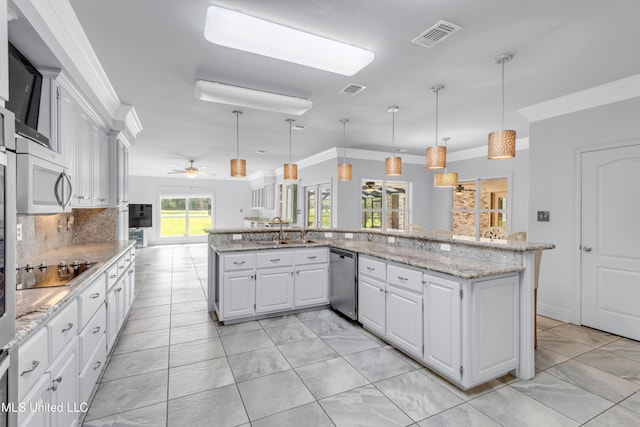 7528 Crooked Stick Dr, Diamondhead, MS 39525 - kitchen with stainless steel appliances, ornamental molding, white cabinets, light marble finish floors, and ceiling fan