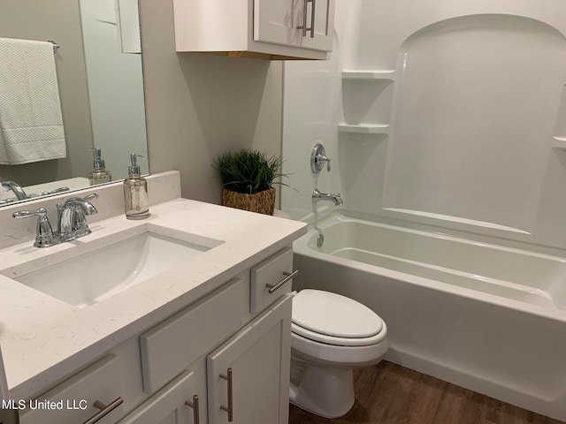 full bathroom featuring vanity, hardwood / wood-style flooring, shower / tub combination, and toilet