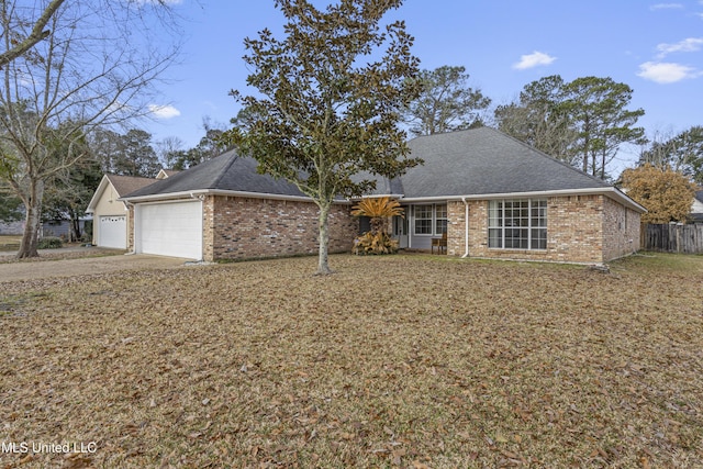 view of front of house featuring a garage and a front lawn