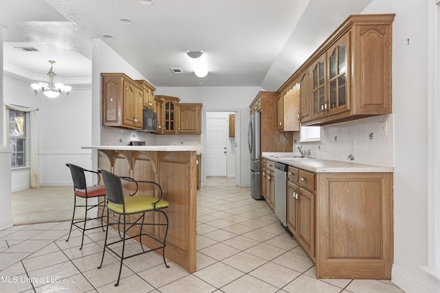 kitchen featuring sink, light tile patterned floors, decorative backsplash, and appliances with stainless steel finishes