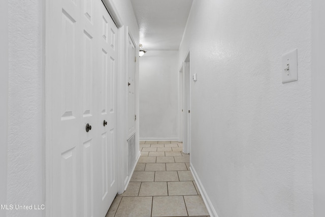 corridor featuring light tile patterned floors