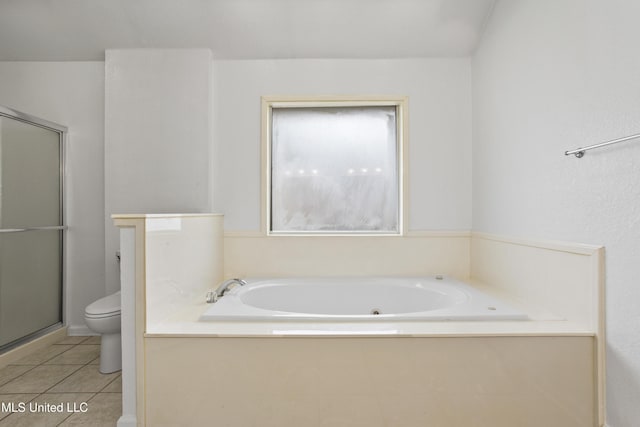 bathroom with tile patterned floors, toilet, and separate shower and tub