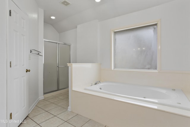 bathroom featuring vaulted ceiling, independent shower and bath, and tile patterned flooring