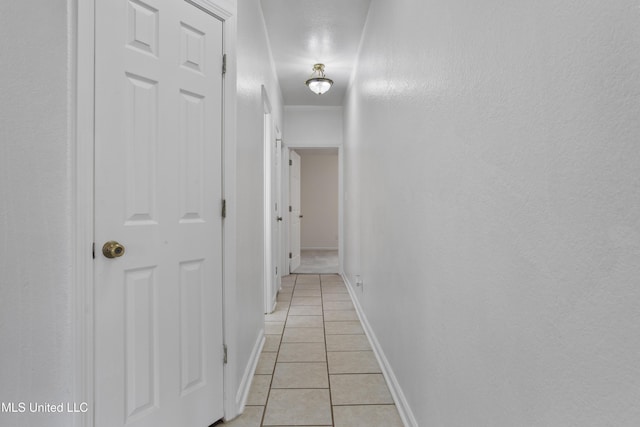 hall with light tile patterned flooring