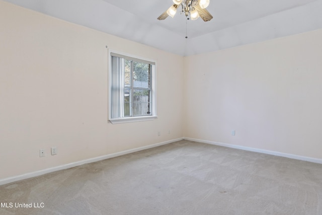 carpeted empty room featuring ceiling fan and vaulted ceiling