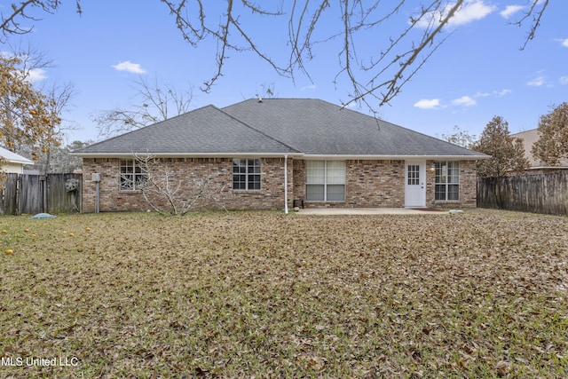 back of property featuring a patio area and a lawn