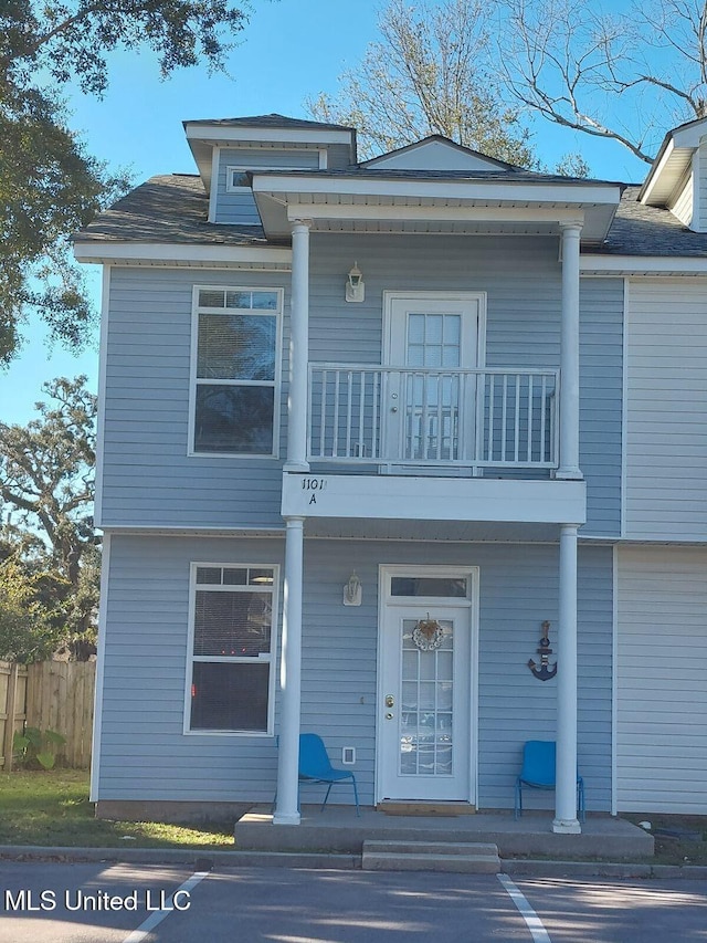 view of front of house featuring a balcony