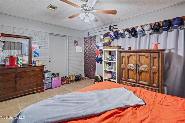 560 Bailey St, Mendenhall, MS 39114 - tiled bedroom with a textured ceiling and a ceiling fan