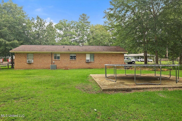 560 Bailey St, Mendenhall, MS 39114 - rear view of house featuring a yard, brick siding, central AC unit, and cooling unit