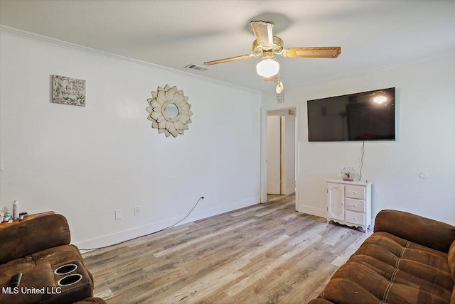 560 Bailey St, Mendenhall, MS 39114 - living room with ornamental molding, light wood-style flooring, a ceiling fan, and baseboards
