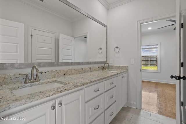 full bath featuring double vanity, a sink, and crown molding