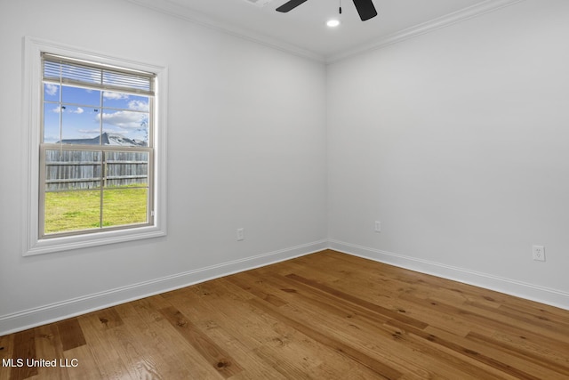 unfurnished room featuring a ceiling fan, baseboards, ornamental molding, and wood finished floors