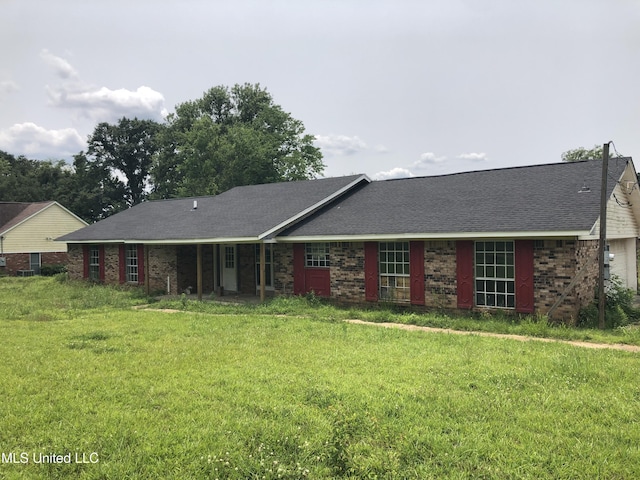 303 Old Spanish Trl, Jackson, MS 39212 - ranch-style house with a front yard, roof with shingles, and brick siding