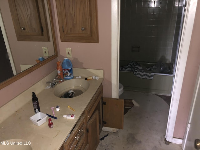 303 Old Spanish Trl, Jackson, MS 39212 - bathroom featuring toilet, unfinished concrete floors, vanity, and tub / shower combination
