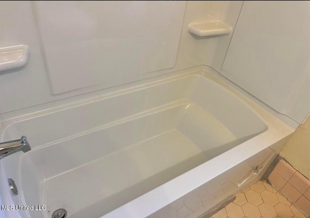 bathroom featuring a bathing tub and tile patterned flooring