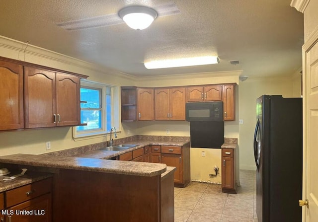 kitchen featuring a peninsula, a textured ceiling, a sink, light tile patterned floors, and black appliances