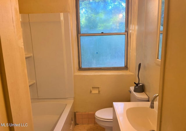 bathroom with toilet, vanity, tile patterned floors, and a bath