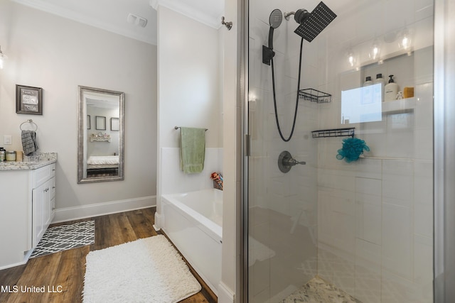 bathroom with vanity, hardwood / wood-style flooring, ornamental molding, and separate shower and tub