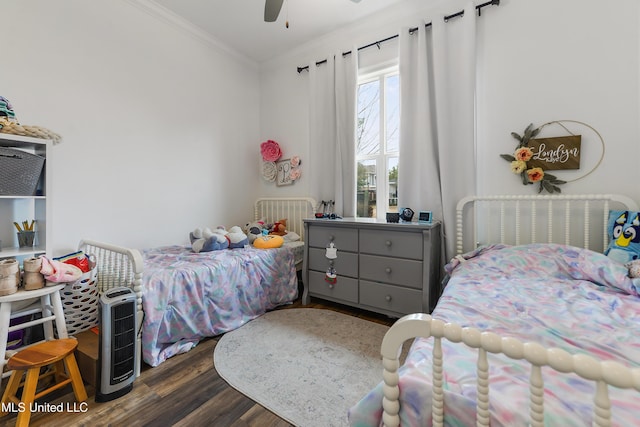 bedroom featuring crown molding, dark hardwood / wood-style flooring, and ceiling fan