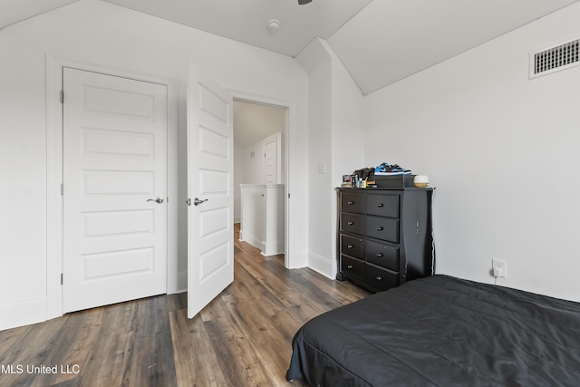 bedroom featuring lofted ceiling and dark wood-type flooring