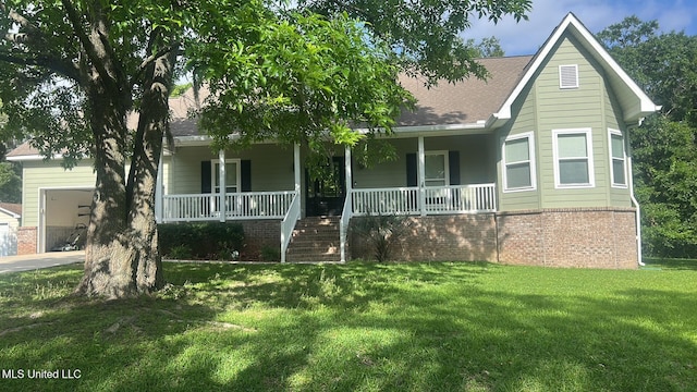 4509 Hickory St, Pascagoula, MS 39567 - view of front of property featuring a porch, a shingled roof, an attached garage, a front lawn, and brick siding