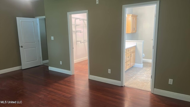 4509 Hickory St, Pascagoula, MS 39567 - unfurnished bedroom with wood finished floors, a spacious closet, and ensuite bathroom