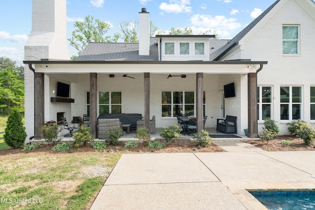 4270 Sunset Rd, Nesbit, MS 38651 - rear view of property featuring a patio, a large fireplace, a chimney, and a ceiling fan