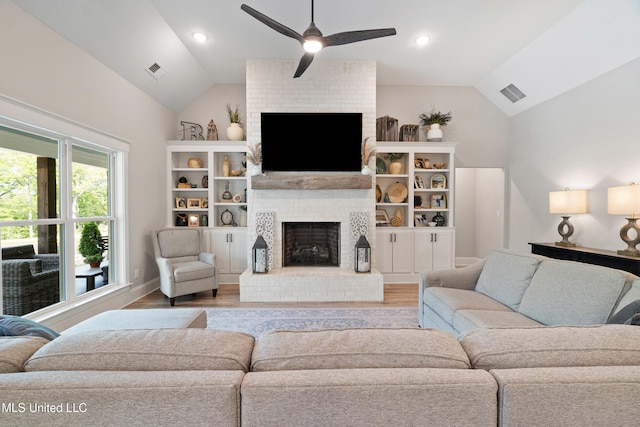 4270 Sunset Rd, Nesbit, MS 38651 - living area with a ceiling fan, visible vents, vaulted ceiling, and a fireplace
