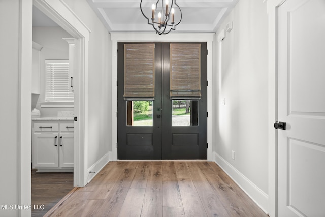 4270 Sunset Rd, Nesbit, MS 38651 - foyer entrance featuring an inviting chandelier, light wood-style flooring, french doors, and baseboards