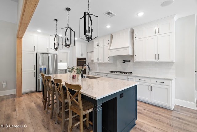 4270 Sunset Rd, Nesbit, MS 38651 - kitchen featuring baseboards, custom exhaust hood, appliances with stainless steel finishes, and a sink