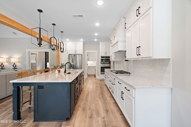 4270 Sunset Rd, Nesbit, MS 38651 - kitchen with a breakfast bar area, visible vents, white cabinetry, and a sink