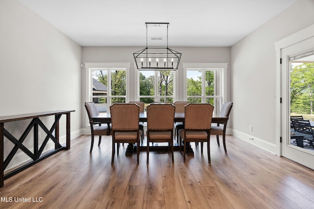 4270 Sunset Rd, Nesbit, MS 38651 - dining room featuring baseboards, wood finished floors, and an inviting chandelier