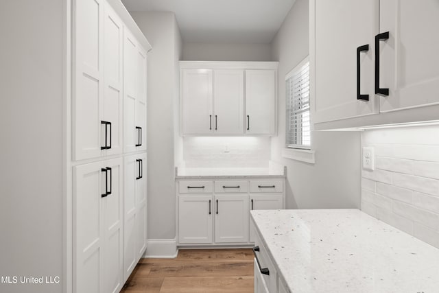 4270 Sunset Rd, Nesbit, MS 38651 - kitchen featuring light wood finished floors, light stone countertops, and decorative backsplash